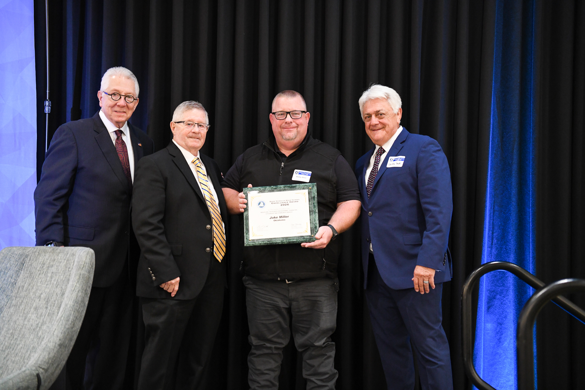 Jake's dad Bobby Miller receiving Dave Schultz High School Excellence Award from A.L. Haizlip, Steve Ferguson, and Lee Roy Smith. Jake is wrestling at Iowa State University and unable to attend